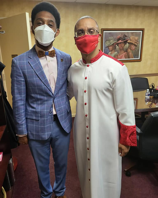 Mayor Scott standing with religious figure